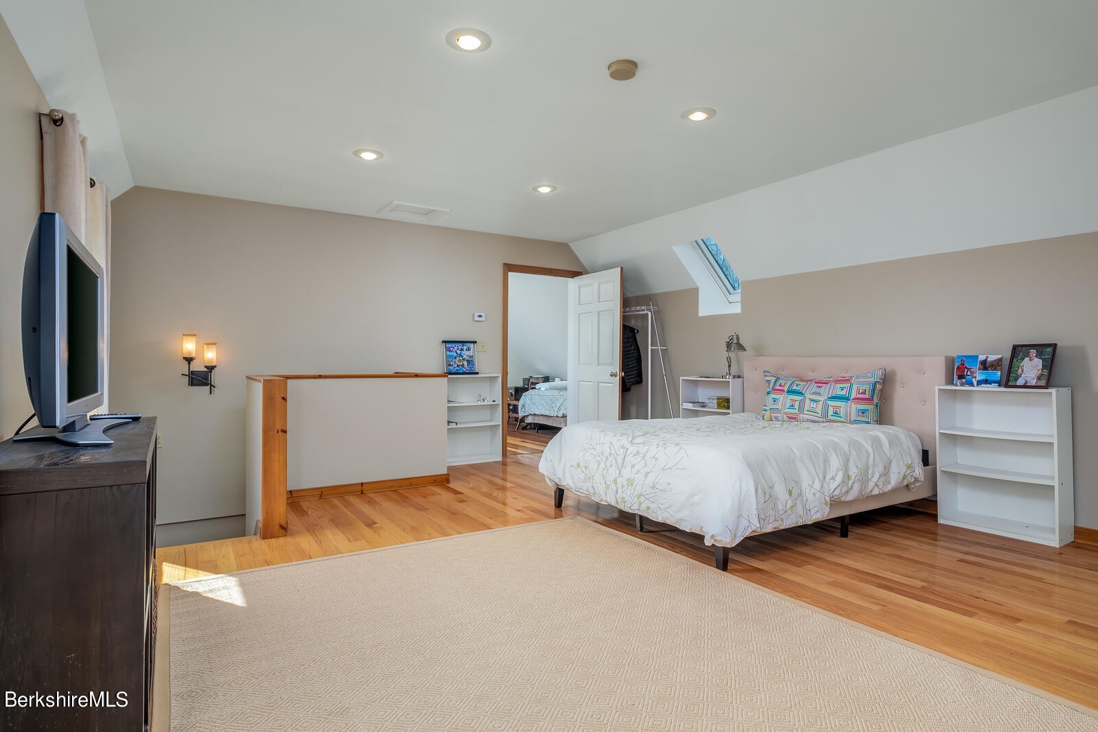 491 Henderson Road Williamstown, MA 01267 - Photo 30 of 42 a spacious bedroom with a bed and a flat screen tv