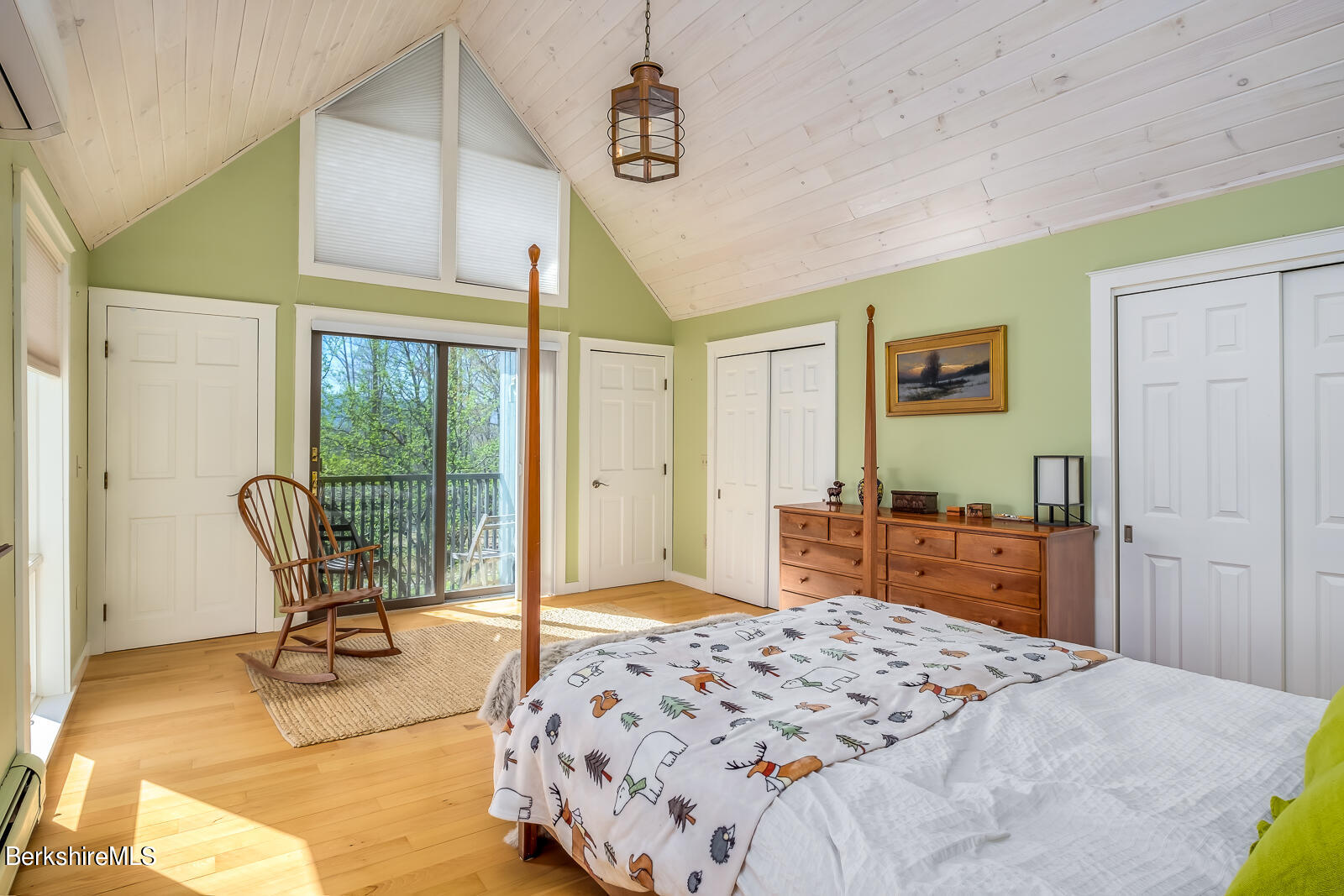 491 Henderson Road Williamstown, MA 01267 - Photo 32 of 42 a bedroom with a bed large window with chair and glass door