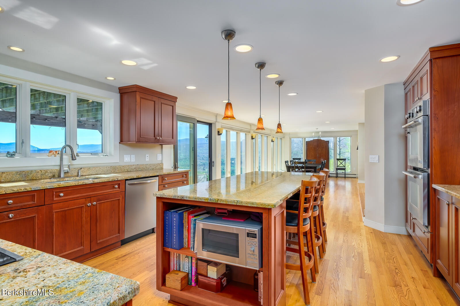 491 Henderson Road Williamstown, MA 01267 - Photo 9 of 42 a kitchen with stainless steel appliances granite countertop a sink a stove a refrigerator cabinets and living room view