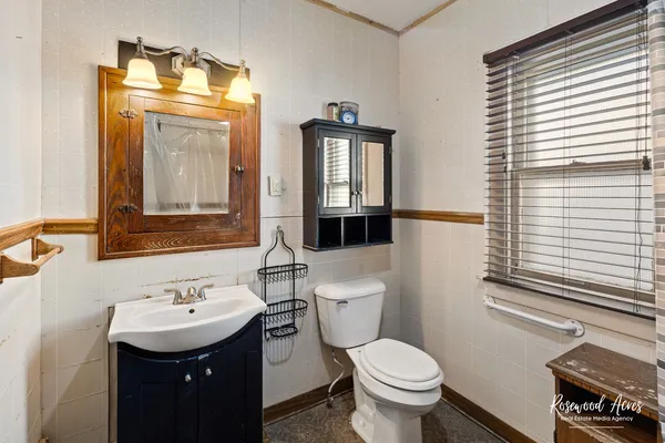 a bathroom with a toilet sink and mirror