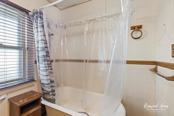 a bathroom with a shower and a sink