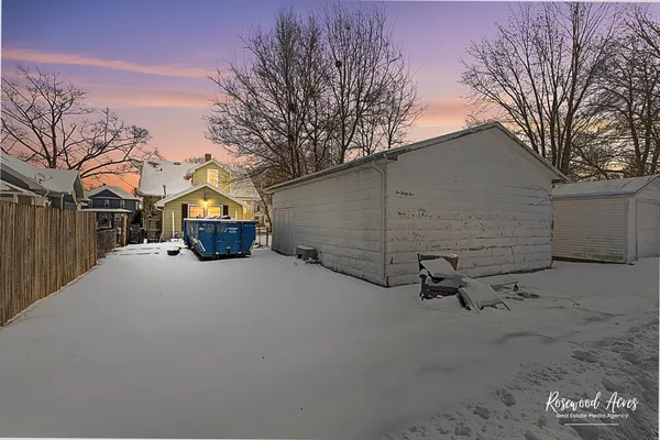 a view of garage and wooden fence