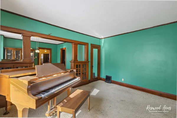 a room with pool table and a large window