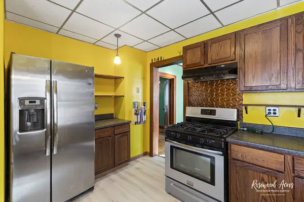 a kitchen with stainless steel appliances granite countertop a stove a refrigerator and a microwave