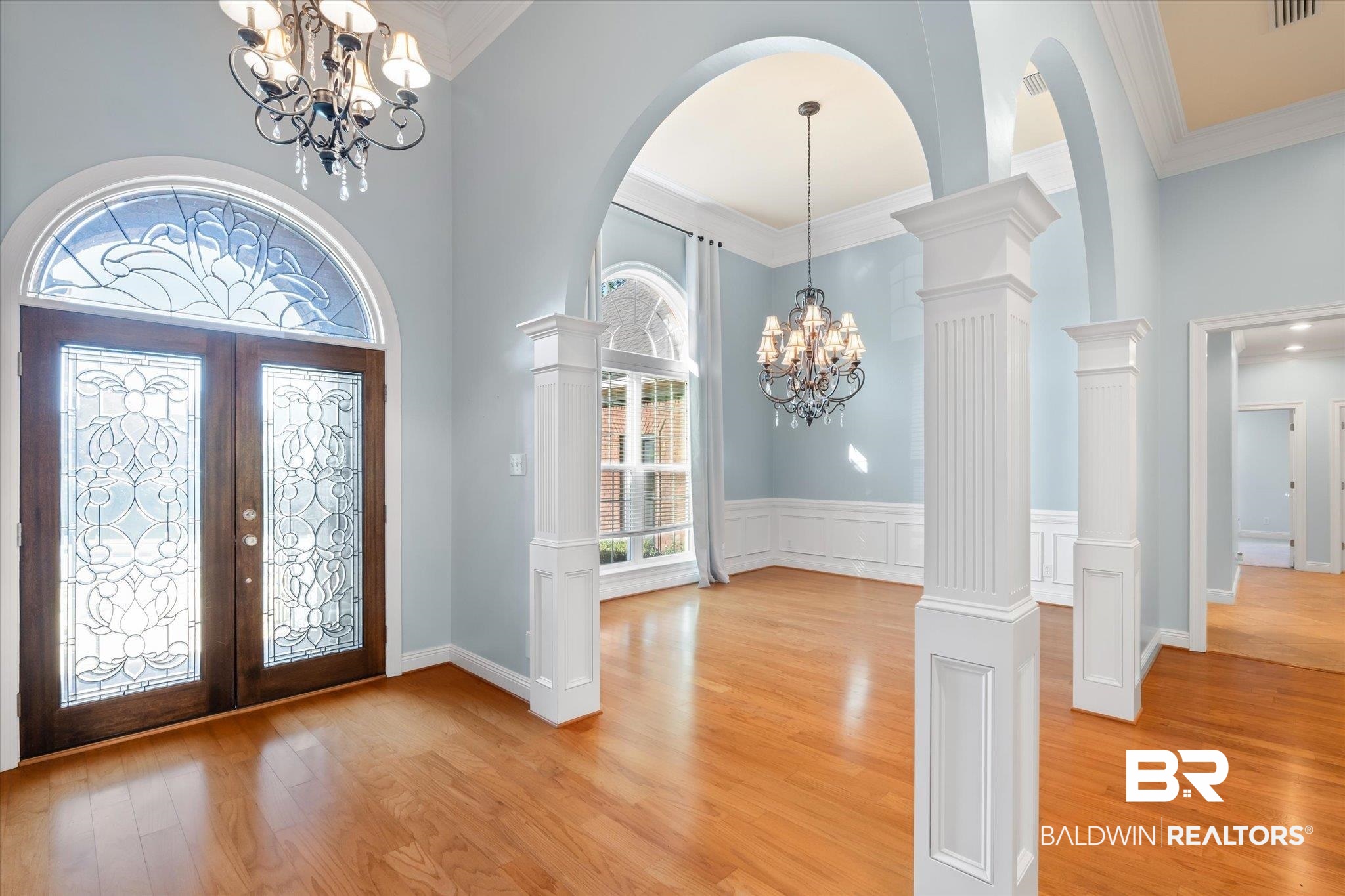 10730 Flagstone Drive Mobile, AL 36608 - Photo 2 of 20 Foyer featuring an inviting chandelier, decorative columns, a high ceiling, light hardwood / wood-style floors, and french doors