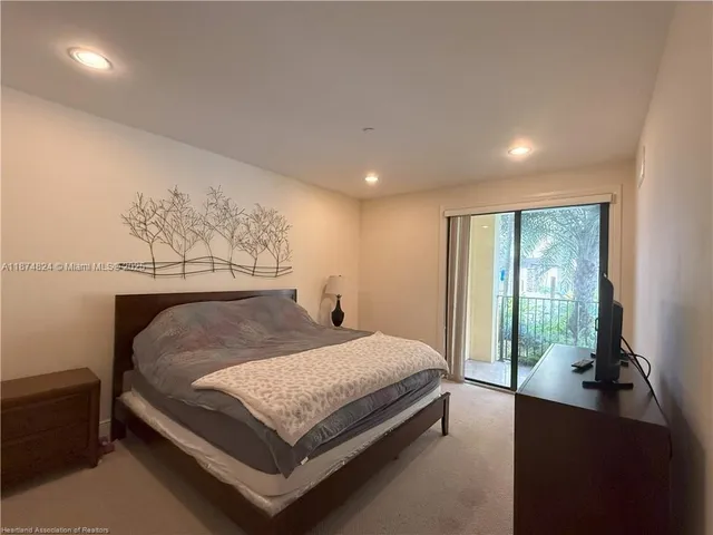 a bed sitting in a spacious bedroom next to a window