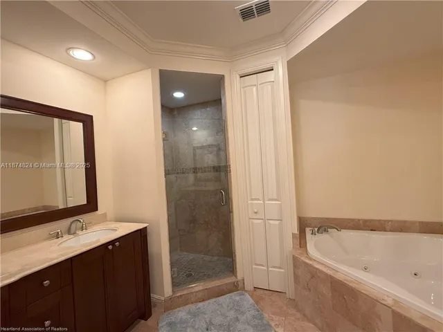 a bathroom with a tub sink and mirror