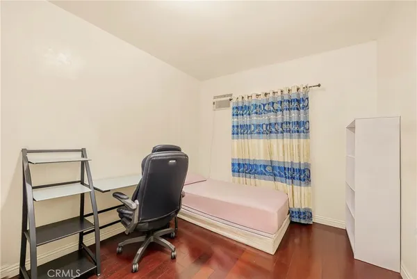 a bedroom with a bed and a chair