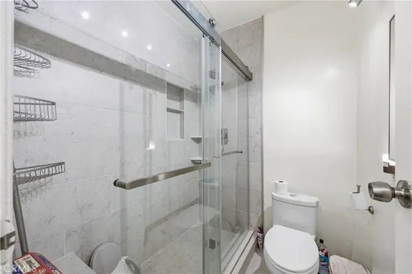 a bathroom with a toilet and a shower