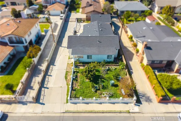 an aerial view of residential houses with yard