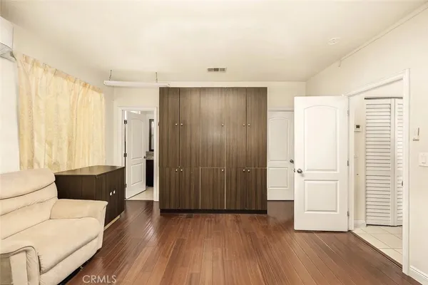 a view of a livingroom with a hardwood floor and a window