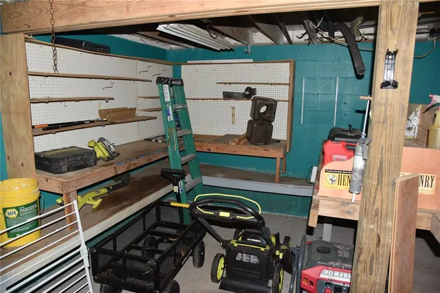 a view of a garage with wooden table and chairs