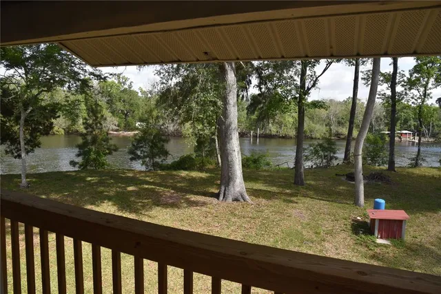 a view of a wooden deck with a back yard