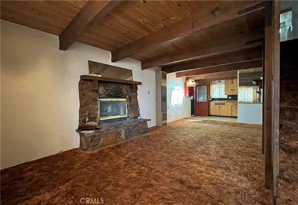 a large kitchen with a large window a stove and a refrigerator