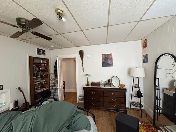 a bedroom with a bed and wooden floor