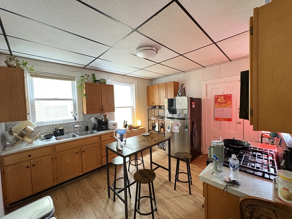 137 Centre Street, Unit 2 Boston, MA 02119 - Photo 6 of 8 a room with furniture a wooden floor and a window