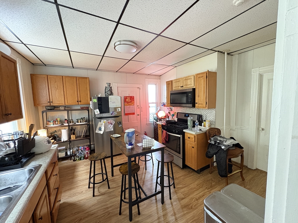 137 Centre Street, Unit 2 Boston, MA 02119 - Photo 7 of 8 a view of a dining room with furniture window and wooden floor