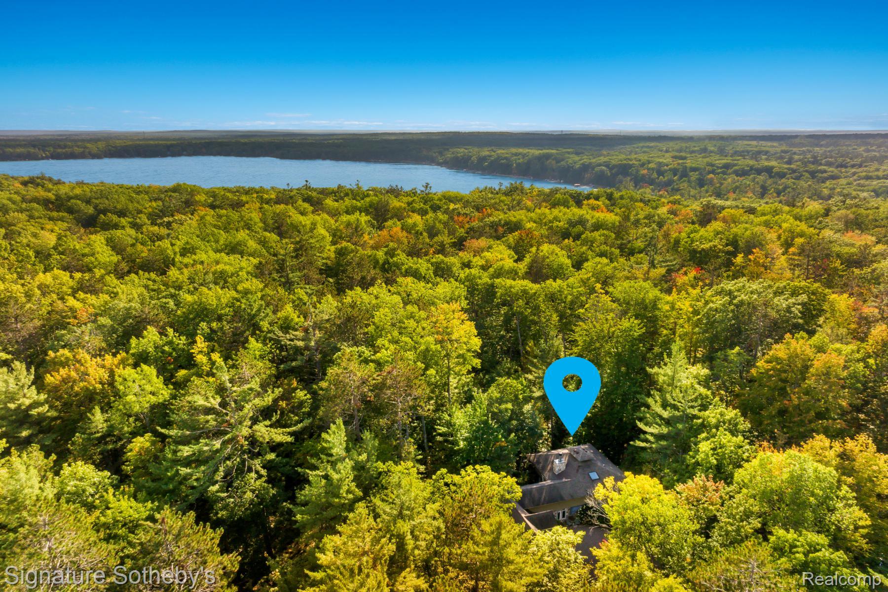 11436 Lakeview Road Northeast Kalkaska, MI 49646 - Photo 2 of 29 Bird's eye view of a forest and a nearby body of water