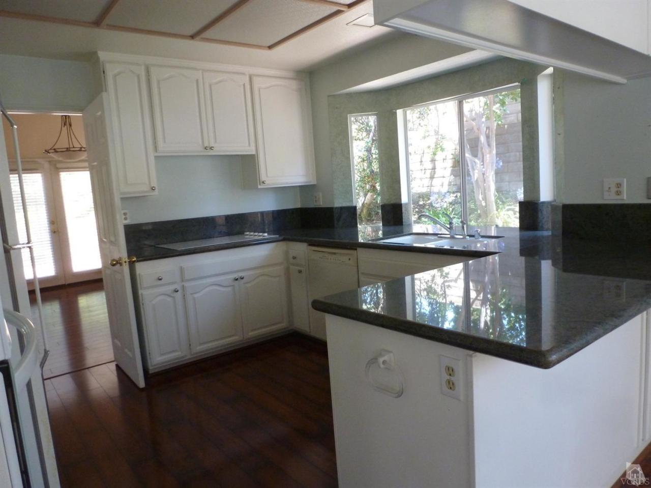 493 Innwood Road Simi Valley, CA 93065 - Photo 15 of 34 a kitchen with granite countertop white cabinets a sink a window and a stainless steel appliances