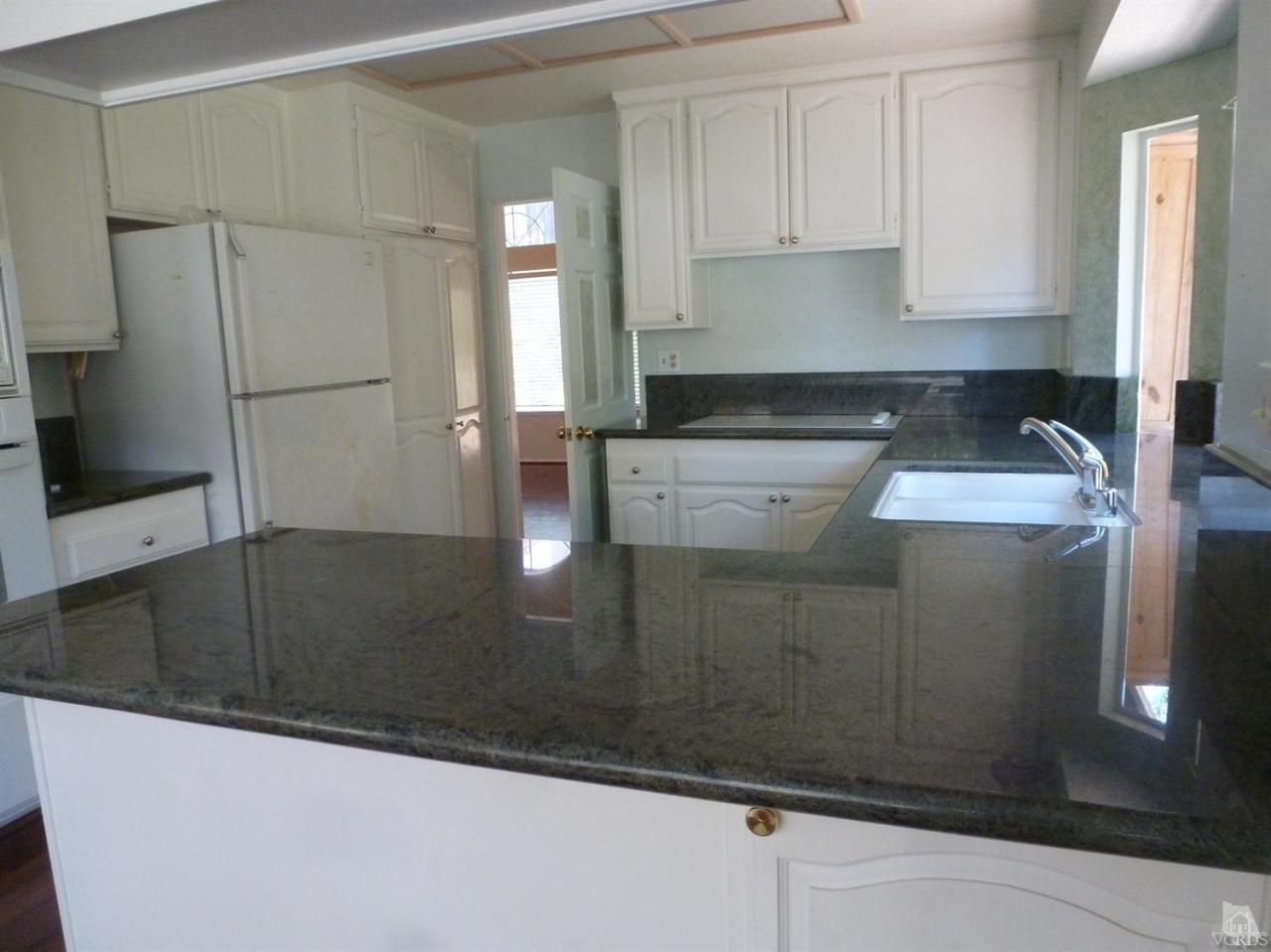 493 Innwood Road Simi Valley, CA 93065 - Photo 16 of 34 a kitchen with stainless steel appliances granite countertop a sink a refrigerator and a granite counter tops