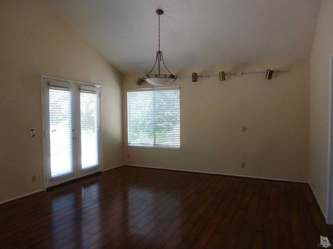 493 Innwood Road Simi Valley, CA 93065 - Photo 17 of 34 an empty room with wooden floor and windows