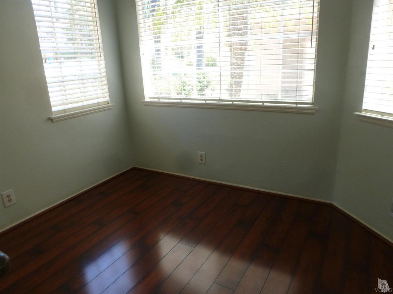 493 Innwood Road Simi Valley, CA 93065 - Photo 20 of 34 an empty room with wooden floor and windows