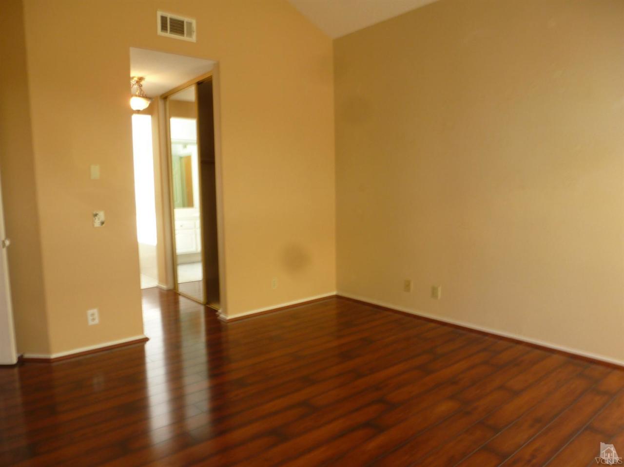 493 Innwood Road Simi Valley, CA 93065 - Photo 27 of 34 a view of an empty room with wooden floor and a window