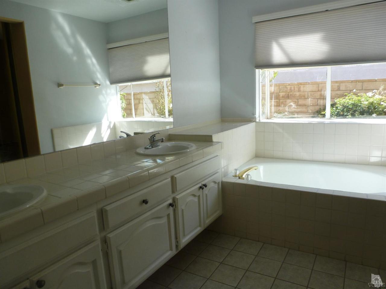 493 Innwood Road Simi Valley, CA 93065 - Photo 28 of 34 a bathroom with a granite countertop sink and a bathtub