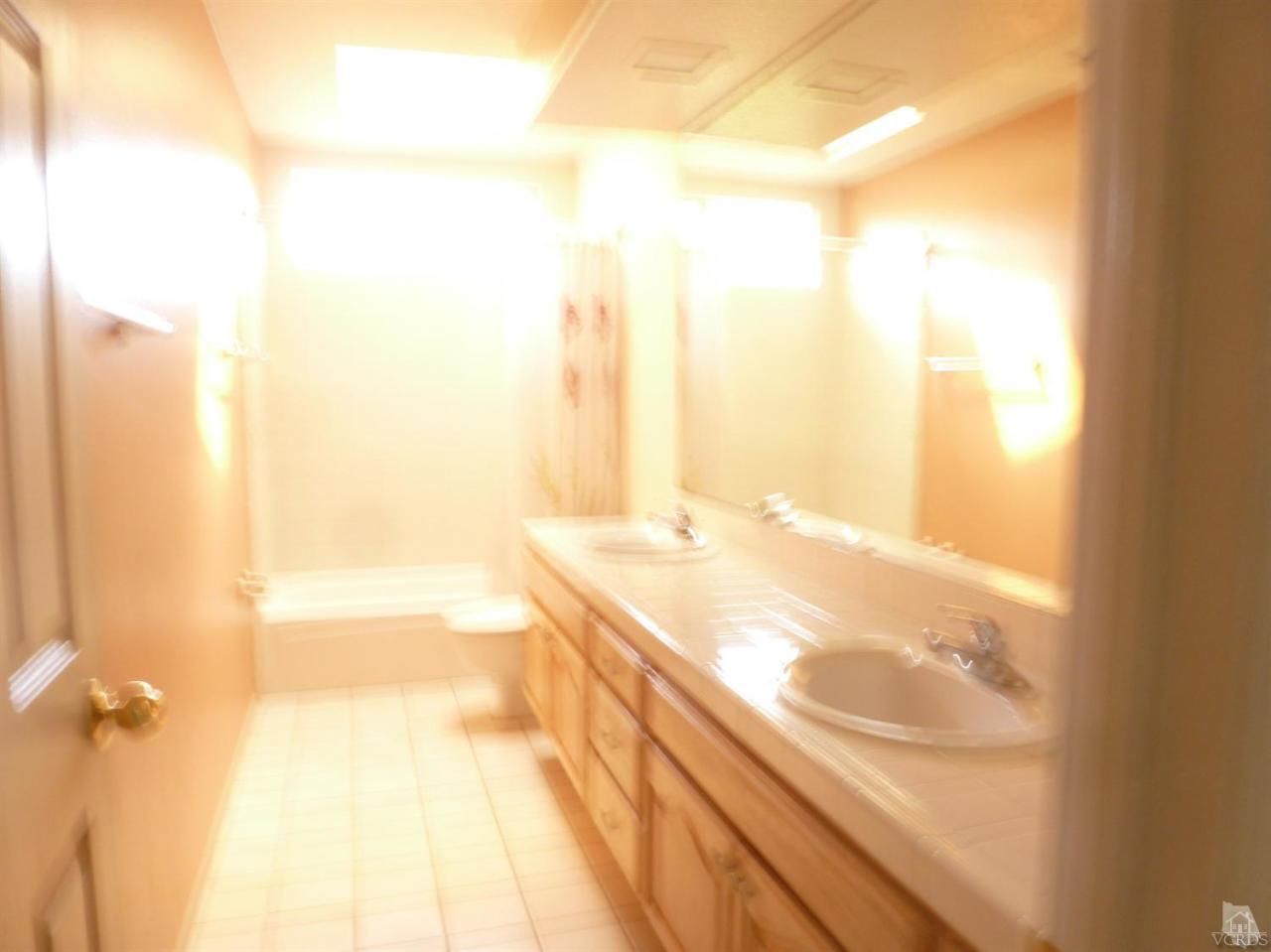 493 Innwood Road Simi Valley, CA 93065 - Photo 30 of 34 a bathroom with a granite countertop sink and a shower