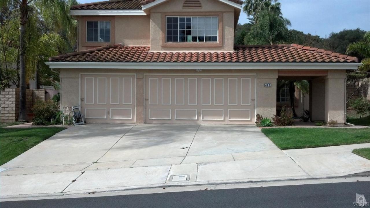 493 Innwood Road Simi Valley, CA 93065 - Photo 34 of 34 a front view of a house with a garden and garage