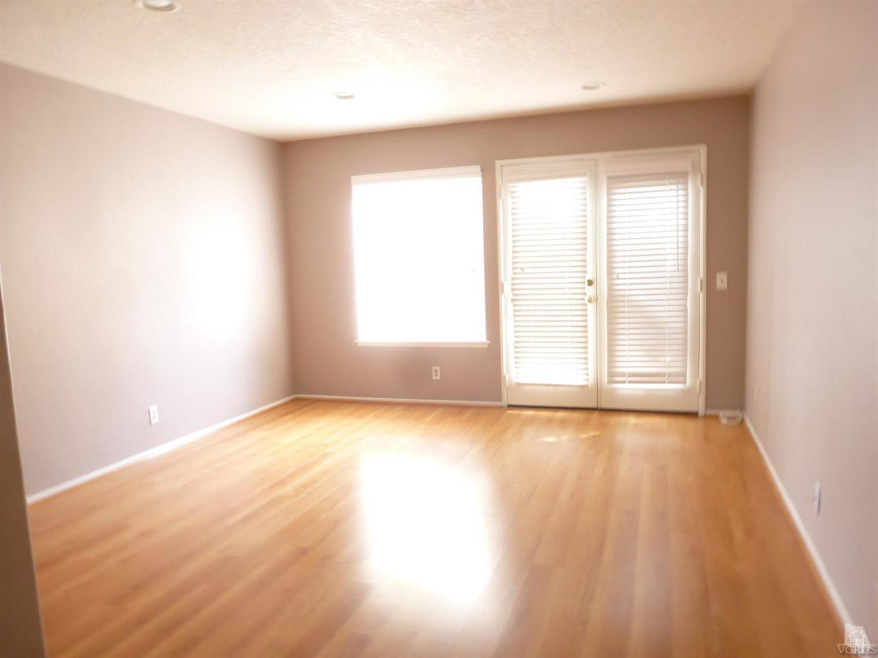 493 Innwood Road Simi Valley, CA 93065 - Photo 8 of 34 an empty room with wooden floor and windows