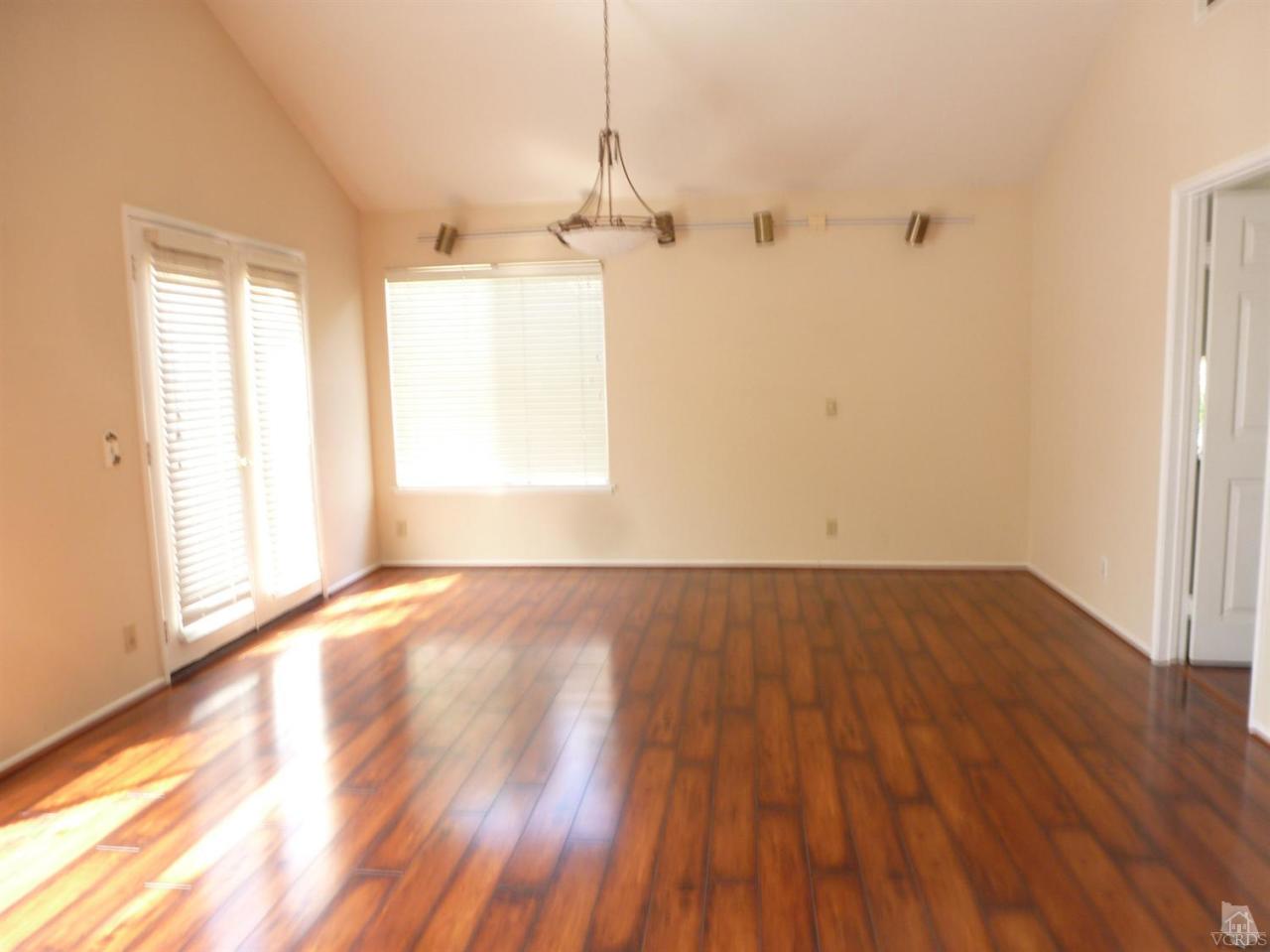 493 Innwood Road Simi Valley, CA 93065 - Photo 9 of 34 an empty room with wooden floor and windows