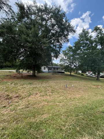a view of outdoor space with deck and trees