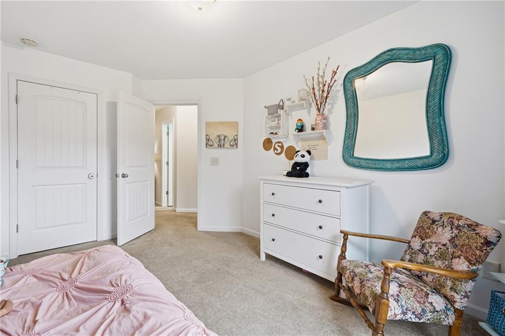 615 Myers Gate Road Ball Ground, GA 30107 - Photo 27 of 43 a bedroom with a bed and a dresser in it