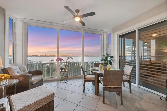 a living room with furniture and a floor to ceiling window