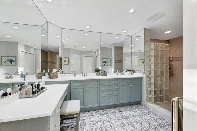 a large bathroom with a sink a large mirror and shower
