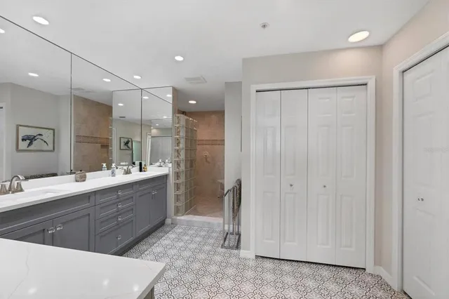 a spacious bathroom with a mirror a double vanity sink and a mirror