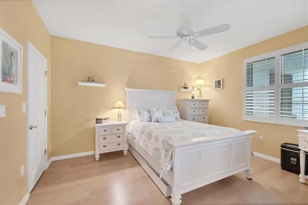 a bedroom with a bed and a ceiling fan