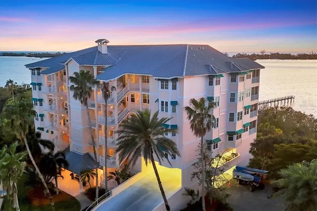 a view of a house with a yard and potted plants