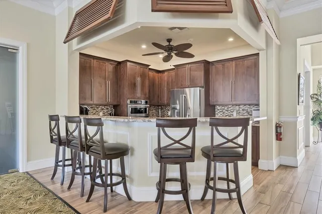 a large kitchen with granite countertop a stove and a sink