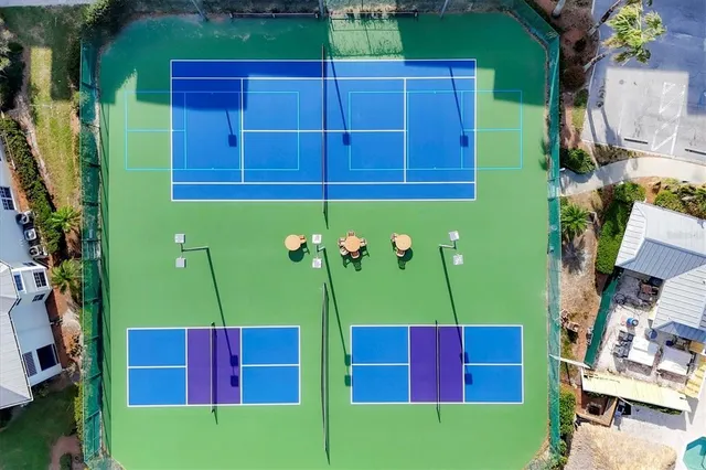 a view of a pool with a lawn chairs