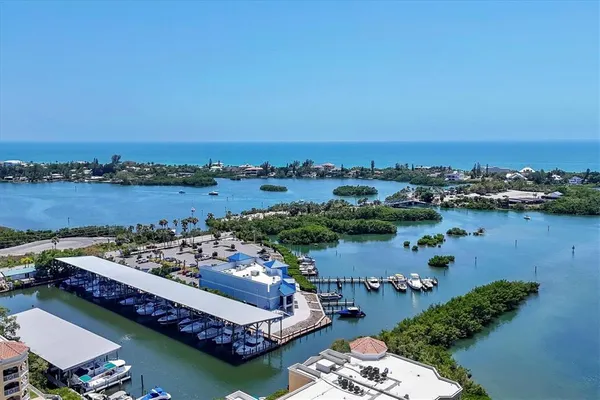 an aerial view of a house with a yard and lake view