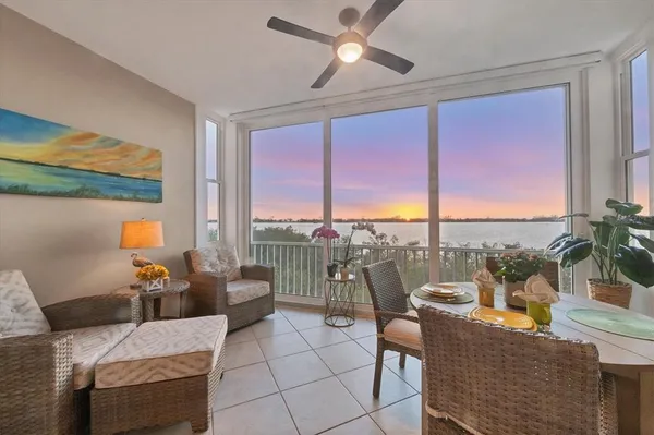 a living room with furniture and a floor to ceiling window