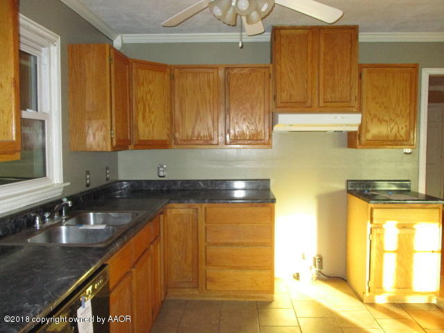 4124 South Lipscomb Street Amarillo, TX 79110 - Photo 12 of 18 a kitchen with a sink a window and cabinets