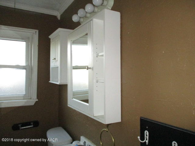 4124 South Lipscomb Street Amarillo, TX 79110 - Photo 5 of 18 a bathroom with a sink mirror and a window