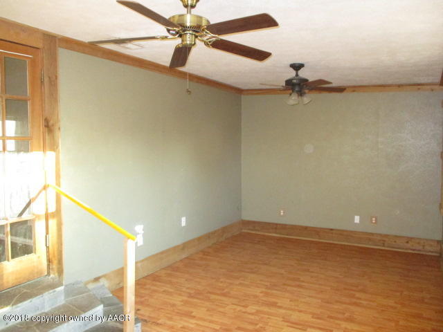 4124 South Lipscomb Street Amarillo, TX 79110 - Photo 9 of 18 a view of a room with a ceiling fan and a window