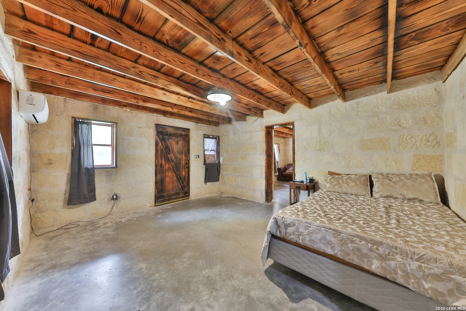 122 Brink Center Point, TX 78010 - Photo 15 of 40 a bedroom with a large bed and a chandelier