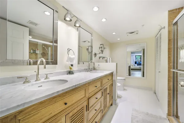 a spacious bathroom with a double vanity sink shower and a mirror