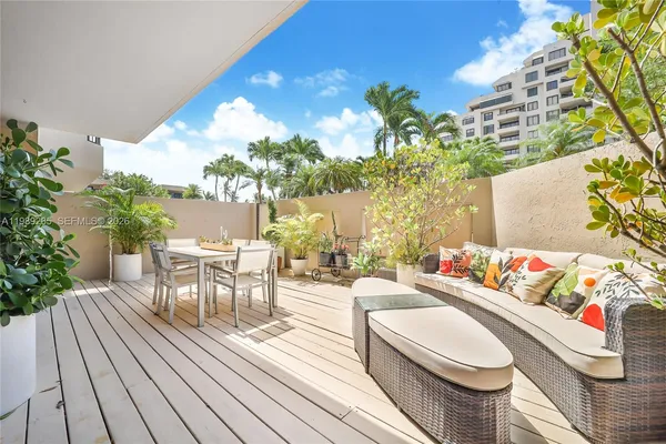 a outdoor living room with furniture and a potted plant