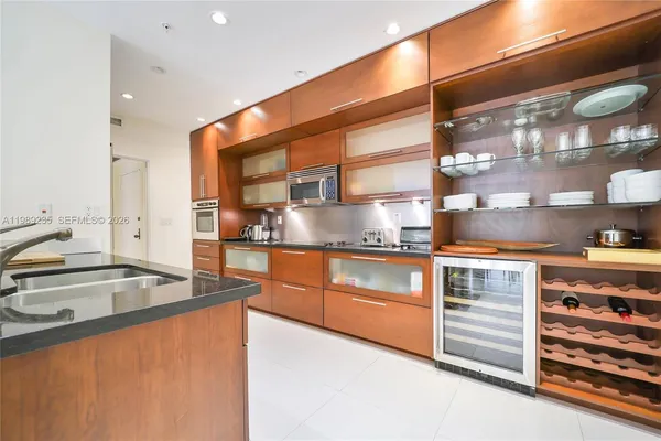 a kitchen with stainless steel appliances granite countertop a sink and a stove